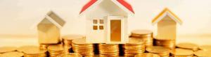 3 houses sitting on coins